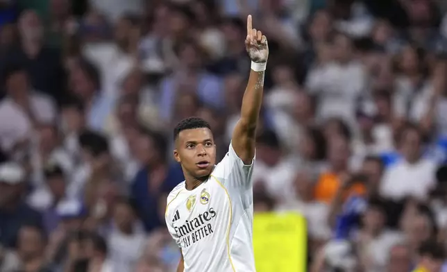 Real Madrid's Kylian Mbappe celebrates after scoring his side's second goal during a Champions League opening phase soccer match between Real Madrid and Marseille at Santiago Bernabeu stadium, in Madrid, Tuesday, Sept. 16, 2025. (AP Photo/Manu Fernandez)