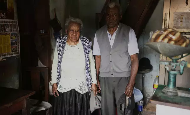 Julio Pinedo, a symbolic leader regarded as the king of the Afro-Bolivians, and his wife Angelica Larrea, pose for a photo in their home in Mururata, Bolivia, Sunday, Aug. 3, 2025. (AP Photo/Juan Karita)