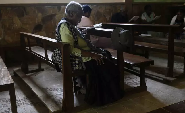 Angelica Larrea, wife of Julio Pinedo, a symbolic leader who is regarded as the king of the Afro-Bolivians, attends a service at the Catholic Church of Tocana, Bolivia, Sunday, Aug. 3, 2025. (AP Photo/Juan Karita)