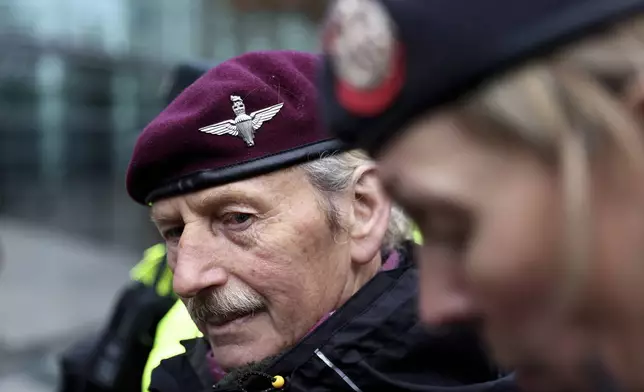 Supporters of soldier F stand outside of Belfast Crown Court, where the trial of a former paratrooper accused of the murder of two men on Bloody Sunday is taking place, in Belfast, Northern Ireland, Monday, Sept. 15, 2025. (AP Photo/Peter Morrison)
