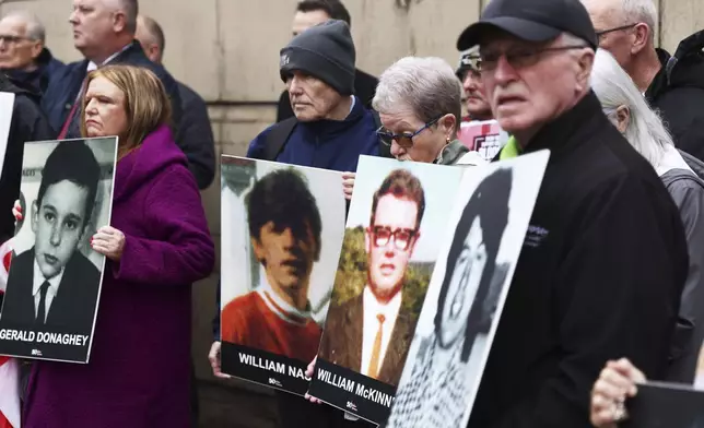 Families of the victims of the 1972 Bloody Sunday, hold a protest outside Belfast Crown court, Northern Ireland, Monday Sept. 15, 2025. (AP Photo/Peter Morrison)