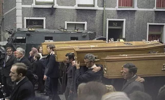 Coffins of people killed during the Bloody Sunday disturbances are carried during their funeral, in Belfast, in February 1972. (AP Photo/Michel Laurent, File)