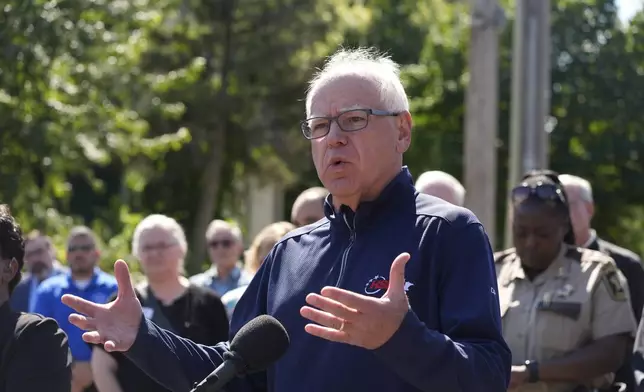 Minnesota Gov. Tim Walz speaks outside the Annunciation Catholic School following a shooting Wednesday, Aug. 27, 2025, in Minneapolis. (AP Photo/Bruce Kluckhohn)