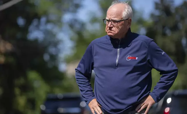 Minnesota Governor Tim Walz waits for a press conference to start outside Annunciation Church after a shooting earlier in Minneapolis, Wednesday, Aug. 27, 2025. (Alex Kormann/Star Tribune via AP)