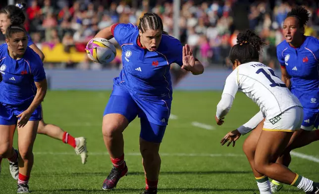 France's Annaelle Deshaye scores a try during the Women's Rugby World Cup 2025 Pool D match between France and Brazil a at Sandy Park, Exeter, England, Sunday Aug. 31, 2025. (Ben Birchall/PA via AP)
