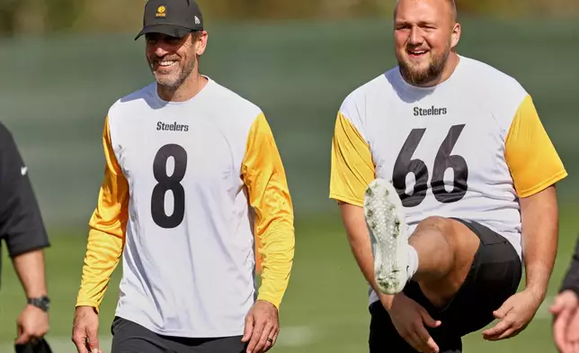 Pittsburgh Steelers quarterback Aaron Rodgers (8) and guard Mason McCormick (66) take part in NFL football practice, Friday, Sept. 26, 2025, ahead of their game against Minnesota Vikings in Dublin. (AP Photo/Peter Morrison)