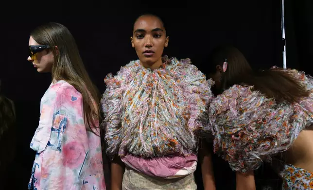 Models wear creations part of the Diesel's Spring Summer 2026 collection in the backstage ahead of the collection's show, in Milan, Italy, Tuesday, Sept. 23, 2025. (AP Photo/Antonio Calanni)