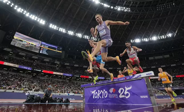 United States' Daniel Michalski, center, Luxembourg's Ruben Querinjean, left, and France's Djilali Bedrani, right, compete in a men's 3,000 meters steeplechase heat at the World Athletics Championships in Tokyo, Saturday, Sept. 13, 2025. (AP Photo/Ashley Landis)