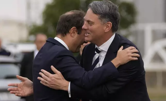 French Defense Minister Sebastien Lecornu, left, welcomes Deputy Prime Minister of Australia and Minister for Defense Richard Marles during a ceremony on Sept. 1, 2022, in Brest, Brittany, France. (AP Photo/Francois Mori, File)