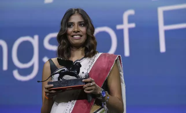 Anuparna Roy accepts the Orizzonti best director award for 'Songs of the Forgotten Trees' during the awards ceremony of the 82nd edition of the Venice Film Festival in Venice, Italy, on Saturday, Sept. 6, 2025. (Photo by Alessandra Tarantino/Invision/AP)