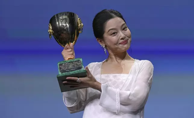Xin Zhilei accepts the Coppa Volpi award for best actress for 'The Sun Rises on Us All' during the awards ceremony of the 82nd edition of the Venice Film Festival in Venice, Italy, on Saturday, Sept. 6, 2025. (Photo by Alessandra Tarantino/Invision/AP)