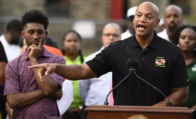 Maryland Gov. Wes Moore, right, speaks next to Baltimore mayor Brandon Scott, left, during a news conference, Friday, Sept. 5, 2025, in Baltimore. (AP Photo/Nick Wass)