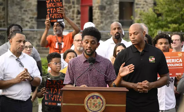Baltimore mayor Brandon Scott, center, speaks next to Maryland Gov. Wes Moore, right, during a news conference, Friday, Sept. 5, 2025, in Baltimore. (AP Photo/Nick Wass)