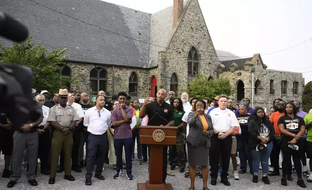 Maryland Gov. Wes Moore, center, speaks next to Baltimore mayor Brandon Scott, left center, during a news conference, Friday, Sept. 5, 2025, in Baltimore. (AP Photo/Nick Wass)