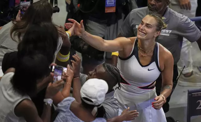 Aryna Sabalenka, of Belarus, celebrates in the crowd after defeating Amanda Anisimova, of the United States, during the women's finals of the U.S. Open tennis championships, Saturday, Sept. 6, 2025, in New York. (AP Photo/Seth Wenig)