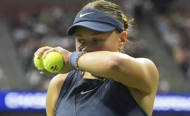 Amanda Anisimova, of the United States, wipes sweat from her face before serving to Aryna Sabalenka, of Belarus, during the women's singles final of the U.S. Open tennis championships, Saturday, Sept. 6, 2025, in New York. (AP Photo/Kirsty Wigglesworth)
