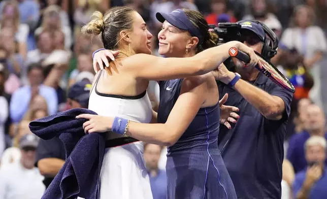 Aryna Sabalenka, of Belarus, hugs Amanda Anisimova, of the United States, after winning the women's finals of the U.S. Open tennis championships, Saturday, Sept. 6, 2025, in New York. (AP Photo/Yuki Iwamura)