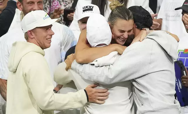 Aryna Sabalenka, of Belarus, hugs supporters after defeating Amanda Anisimova, of the United States, during the women's singles final of the U.S. Open tennis championships, Saturday, Sept. 6, 2025, in New York. (AP Photo/Kirsty Wigglesworth)