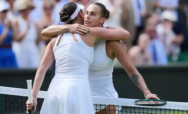 FILE - Belarus' Aryna Sabalenka, right, embraces United States' Amanda Anisimova after losing in a women's singles semifinal match at the Wimbledon Tennis Championships in London, Thursday, July 10, 2025. (AP Photo/Kin Cheung, File)