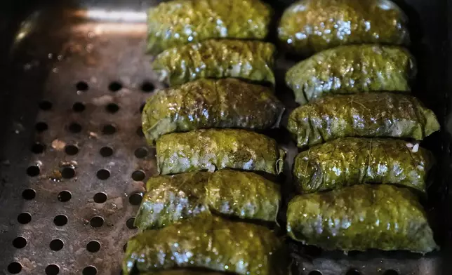 Dolmas, created with locally foraged grape leaves, are prepared in the kitchen for the evening's dinner at the Black Trumpet restaurant at the Black Trumpet restaurant, Tuesday, Sept. 16, 2025, in Portsmouth, N.H. (AP Photo/Charles Krupa)