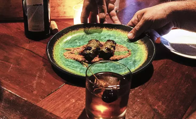 A Dolma appetizer, created with locally foraged grape leaves, are served to a patron at the Black Trumpet restaurant, Tuesday, Sept. 16, 2025, in Portsmouth, N.H. (AP Photo/Charles Krupa)
