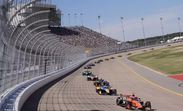 Drivers make their way around the track during an IndyCar auto race Sunday, Aug. 31, 2025, at Nashville Superspeedway in Lebanon, Tenn. (AP Photo/George Walker IV)