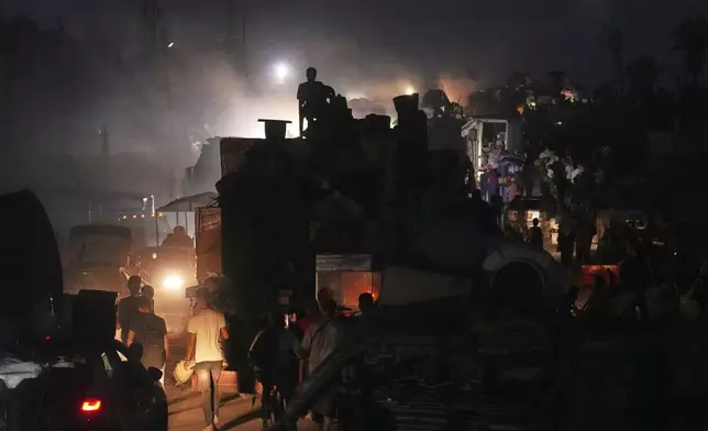 Displaced Palestinians flee Gaza City by foot and vehicles, carrying their belongings along the coastal road toward southern Gaza, Thursday, Sept. 18, 2025. (AP Photo/Abdel Kareem Hana)
