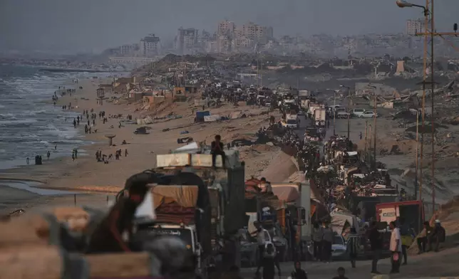 Displaced Palestinians flee Gaza City by foot and vehicles, carrying their belongings along the coastal road toward southern Gaza, Thursday, Sept. 18, 2025. (AP Photo/Abdel Kareem Hana)