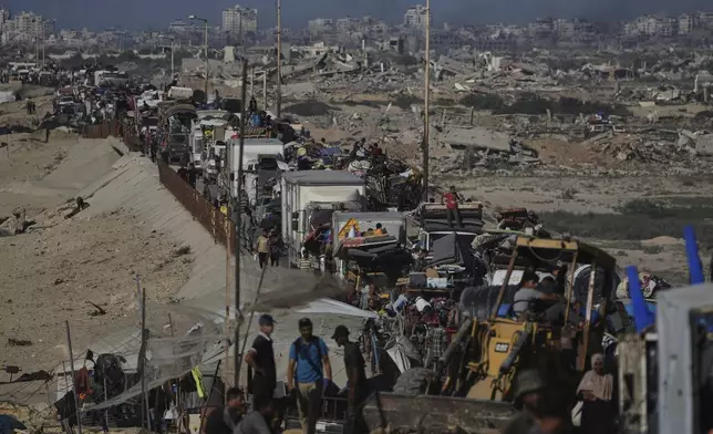 Displaced Palestinians fleeing northern Gaza carry their belongings along the coastal road toward southern Gaza, Wednesday, Sept. 10, 2025, after the Israeli army issued evacuation orders from Gaza City. (AP Photo/Abdel Kareem Hana)