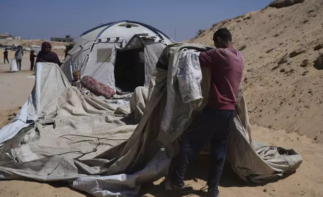 Members of the Abdullah family who were evacuated from Gaza City set up their tent in a camp for displaced Palestinians in Muwasi, an area that Israel has designated as a safe zone, in Khan Younis southern Gaza Strip, Wednesday, Sept. 10, 2025. (AP Photo/Jehad Alshrafi)