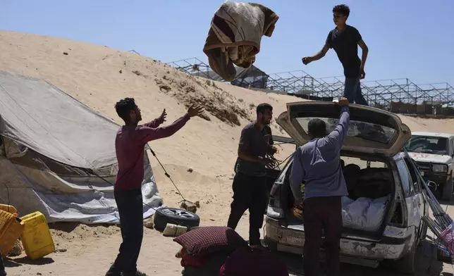 Members of the Abdullah family who were evacuated from Gaza City set up their tent in a camp for displaced Palestinians in Muwasi, an area that Israel has designated as a safe zone, in Khan Younis southern Gaza Strip, Wednesday, Sept. 10, 2025. (AP Photo/Jehad Alshrafi)