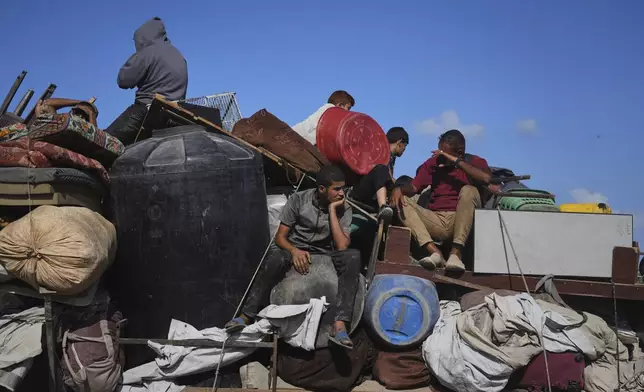 Displaced Palestinians carry their belongings as they flee northern Gaza along the coastal road toward the south, as Israel announced an expanded operation in Gaza City, Tuesday, Sept. 16, 2025. (AP Photo/Abdel Kareem Hana)