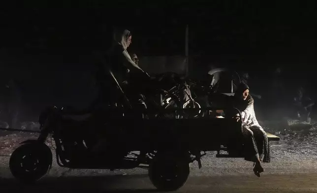 Displaced Palestinians flee Gaza City carrying their belongings along the coastal road toward southern Gaza, Thursday, Sept. 18, 2025. (AP Photo/Abdel Kareem Hana)