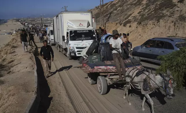 Displaced Palestinians fleeing northern Gaza carry their belongings along the coastal road toward southern Gaza, Wednesday, Sept. 10, 2025, after the Israeli army issued evacuation orders from Gaza City. (AP Photo/Abdel Kareem Hana)