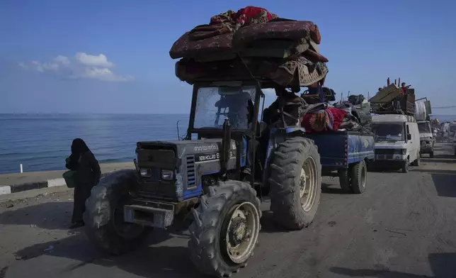 Displaced Palestinians carry their belongings as they flee northern Gaza along the coastal road toward the south, as Israel announced an expanded operation in Gaza City, Tuesday, Sept. 16, 2025. (AP Photo/Abdel Kareem Hana)