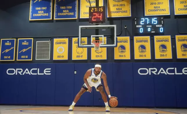 Golden State Warriors guard Moses Moody poses for photos during the NBA basketball team's media day in San Francisco, Monday, Sept. 29, 2025. (AP Photo/Jeff Chiu)