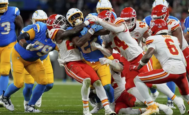 Los Angeles Chargers running back Najee Harris is tackled by the Kansas City Chiefs during the second half of an NFL football game, Friday, Sept. 5, 2025, in Sao Paulo. (AP Photo/Fernando Llano)
