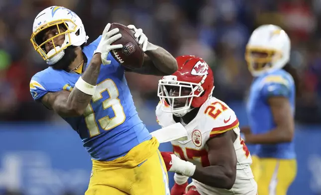 Los Angeles Chargers wide receiver Keenan Allen catches a pass ahead of Kansas City Chiefs safety Chamarri Conner during the second half of an NFL football game, Friday, Sept. 5, 2025, in Sao Paulo. (AP Photo/Jeff Lewis)