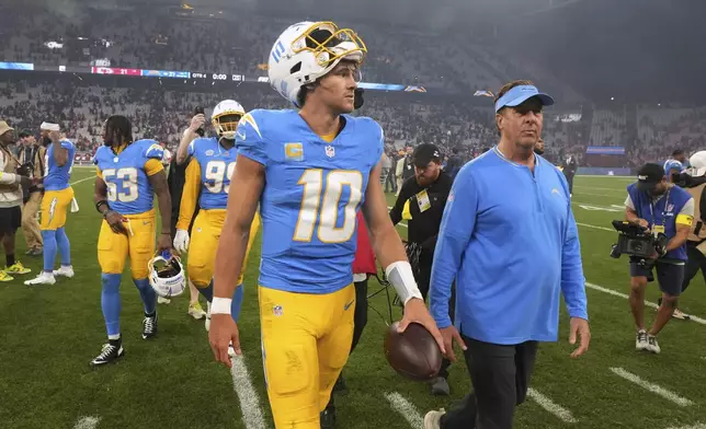 Los Angeles Chargers quarterback Justin Herbert leaves the field after an NFL football game between the Kansas City Chiefs and the Los Angeles Chargers, Saturday, Sept. 6, 2025, in Sao Paulo. (AP Photo/Fernando Llano)