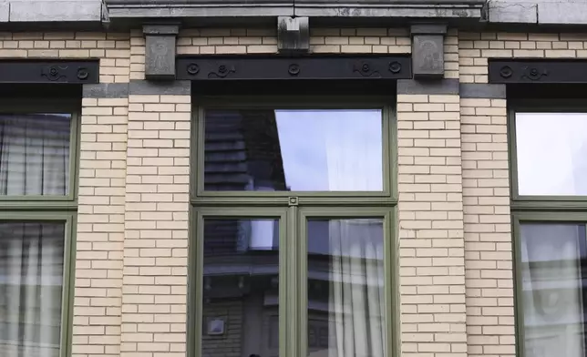 Palestinian and World Peace flags are displayed from a balcony of a house in Antwerp, Belgium, Tuesday, Sept. 2, 2025. (AP Photo/Virginia Mayo)