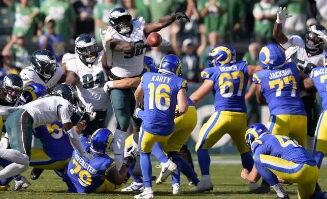 Philadelphia Eagles defensive tackle Jordan Davis (90) blocks a field goal attempt by Los Angeles Rams kicker Joshua Karty (16) before running the ball back for a touchdown as time expires during the second half of an NFL football game against the Los Angeles Rams Sunday, Sept. 21, 2025, in Philadelphia. (AP Photo/Chris Szagola)
