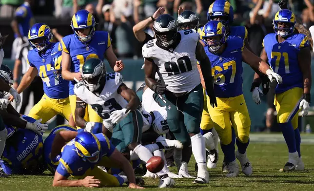 Philadelphia Eagles defensive tackle Jordan Davis (90) blocks a field goal attempt by Los Angeles Rams kicker Joshua Karty (16) before running the ball back for a touchdown as time expires during the second half of an NFL football game against the Los Angeles Rams Sunday, Sept. 21, 2025, in Philadelphia. (AP Photo/Chris Szagola)