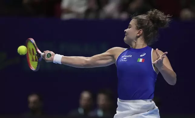 Jasmine Paolini, of Italy returns a forehand shot to Jessica Pegula, of the United States during the Billie Jean King Cup final tennis match, at the Shenzhen Bay Sports Center Arena, in Shenzhen, China's Guangdong province, Sunday, Sept. 21, 2025. (AP Photo/Andy Wong)