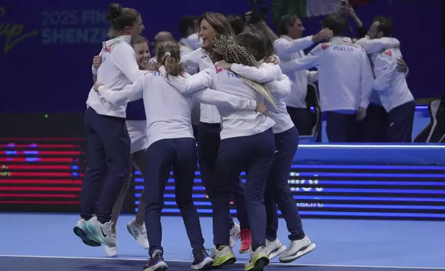 Italy's tennis team celebrate on court after winning the Billie Jean King Cup final against the United States' team, at the Shenzhen Bay Sports Center Arena, in Shenzhen, China's Guangdong province, Sunday, Sept. 21, 2025. (AP Photo/Andy Wong)