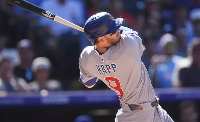 Chicago Cubs' Ian Happ follows through with his swing after connecting for a three-run home run off Colorado Rockies relief pitcher Luis Peralta in the eighth inning of a baseball game Sunday, Aug. 31, 2025, in Denver. (AP Photo/David Zalubowski)