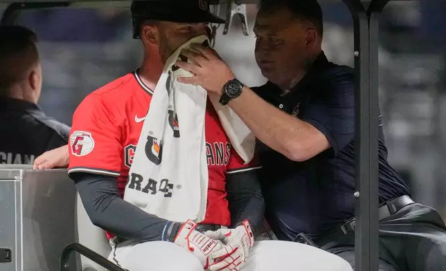 CORRECTION CORRECTS HITTING ON THE FACE BY PITCH - Cleveland Guardians' David Fry is taken off the field after being hit in the face by a pitch in the sixth inning of a baseball game against the Detroit Tigers in Cleveland, Tuesday, Sept. 23, 2025. (AP Photo/Sue Ogrocki)