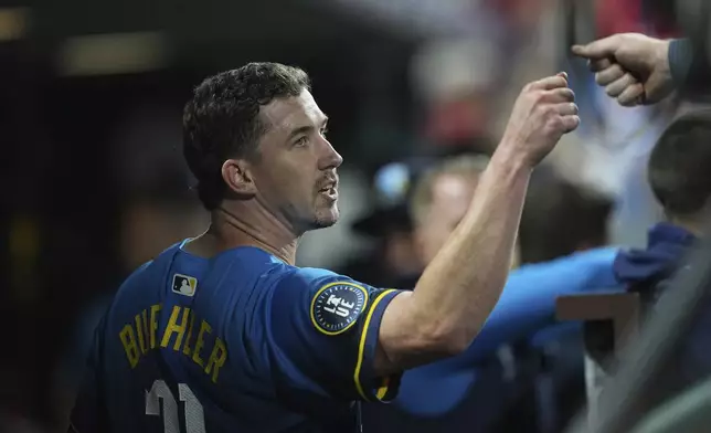 Philadelphia Phillies pitcher Walker Buehler fist bumps Brandon Marsh during the fourth inning of a baseball game against the Kansas City Royals, Friday, Sept. 12, 2025, in Philadelphia. (AP Photo/Matt Rourke)