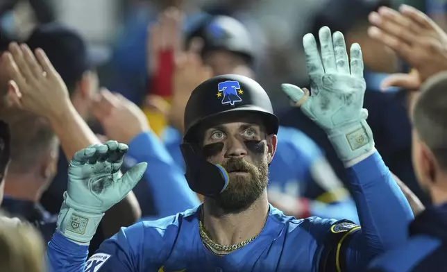 Philadelphia Phillies' Bryce Harper celebrates after his two-run home run off Kansas City Royals pitcher Michael Lorenzen during the third inning of a baseball game, Friday, Sept. 12, 2025, in Philadelphia. (AP Photo/Matt Rourke)
