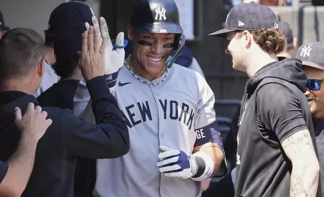 New York Yankees' Aaron Judge celebrates with teammates after hitting a solo home run during the first inning of a baseball game against the Chicago White Sox in Chicago, Sunday, Aug. 31, 2025. (AP Photo/Nam Y. Huh)