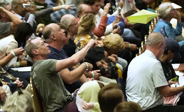 Audience members toss paper airplanes during the award the Ig Nobel Prize award ceremony, Thursday, Sept. 18, 2025, in Boston. (AP Photo/Robert F. Bukaty)